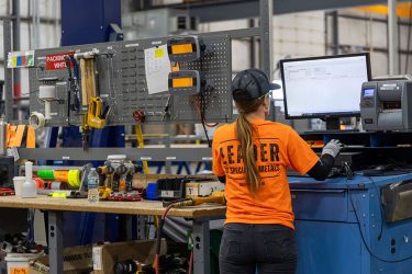 Machine operators working together on a manufacturing team. Rolled Alloys is hiring production team members in Toledo and Cincinnati, Ohio.