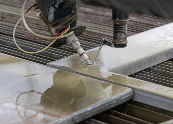 5-axis waterjet bevel cutting examples, including tapered and angled edges, precision holes, and clean cuts on metal parts.